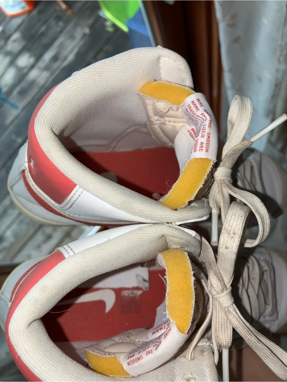 Nike Women's White High-Top Sneakers with Red Swoosh